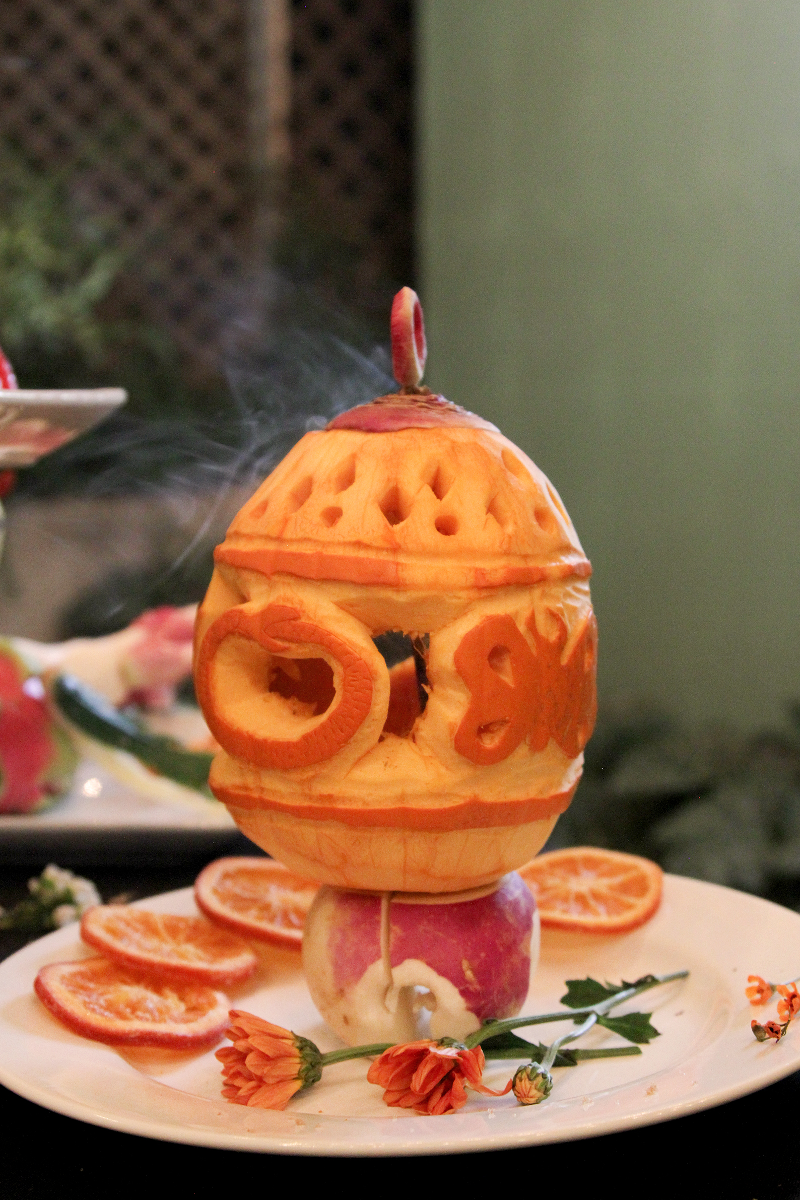 Smoke rising out of a lantern made from pumpkin on a white plate